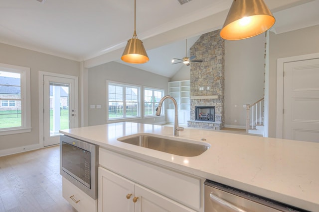 4016 Runyan Cv, Murfreesboro, TN 37127 - kitchen with stainless steel dishwasher, built in microwave, pendant lighting, vaulted ceiling, and light wood finished floors