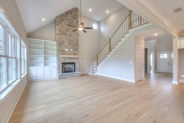 4016 Runyan Cv, Murfreesboro, TN 37127 - unfurnished living room with light wood-type flooring, a ceiling fan, stairs, a stone fireplace, and high vaulted ceiling