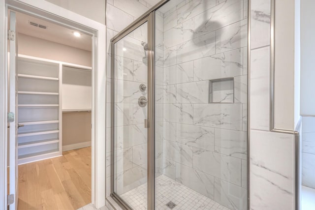 4016 Runyan Cv, Murfreesboro, TN 37127 - bathroom with a stall shower, wood finished floors, and a spacious closet
