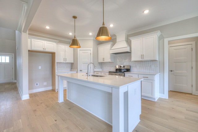 4016 Runyan Cv, Murfreesboro, TN 37127 - kitchen featuring stainless steel range with electric stovetop, premium range hood, light countertops, white cabinets, and tasteful backsplash