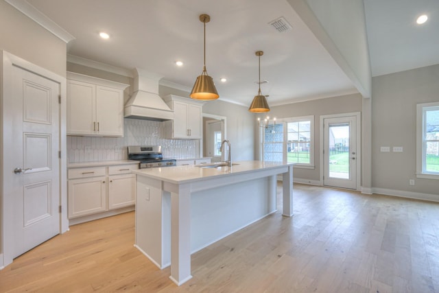 4016 Runyan Cv, Murfreesboro, TN 37127 - kitchen featuring custom range hood, electric range, light countertops, a center island with sink, and white cabinets