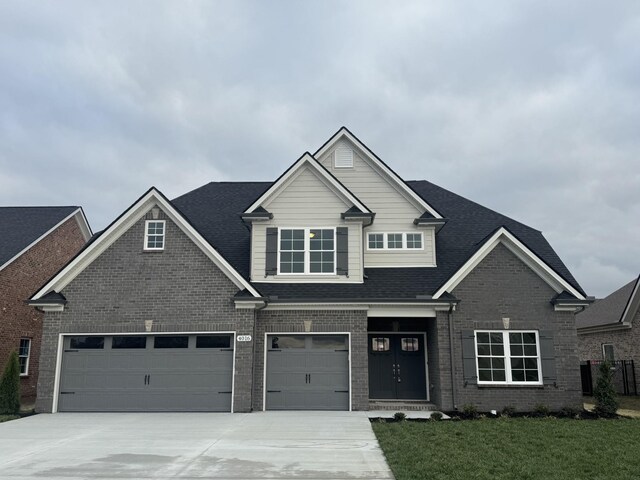 4016 Runyan Cv, Murfreesboro, TN 37127 - view of front of house featuring driveway, a front lawn, brick siding, and roof with shingles