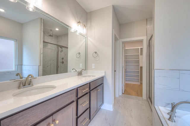 4016 Runyan Cv, Murfreesboro, TN 37127 - full bathroom featuring a stall shower, double vanity, marble finish flooring, a walk in closet, and tiled bath