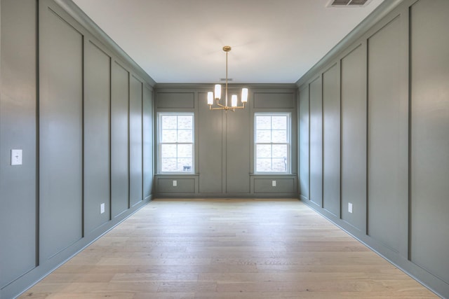 4016 Runyan Cv, Murfreesboro, TN 37127 - unfurnished dining area featuring a decorative wall, a chandelier, and light wood finished floors