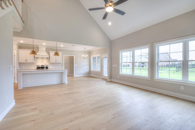 4016 Runyan Cv, Murfreesboro, TN 37127 - unfurnished living room with high vaulted ceiling, light wood-style flooring, a ceiling fan, a chandelier, and recessed lighting