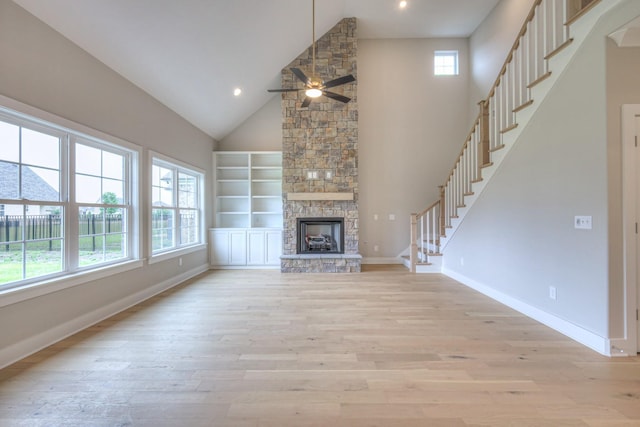 4016 Runyan Cv, Murfreesboro, TN 37127 - unfurnished living room with a ceiling fan, light wood finished floors, high vaulted ceiling, stairway, and a fireplace