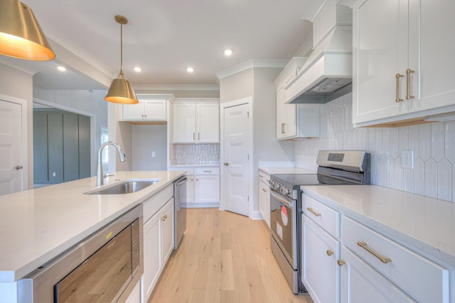 4016 Runyan Cv, Murfreesboro, TN 37127 - kitchen with appliances with stainless steel finishes, premium range hood, white cabinets, light wood-type flooring, and recessed lighting