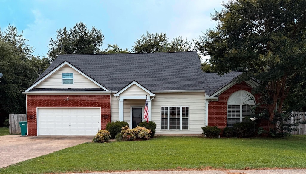 2127 Loudenslager Dr, Thompsons Station, TN 37179 - view of front of house with concrete driveway, roof with shingles, an attached garage, and brick siding