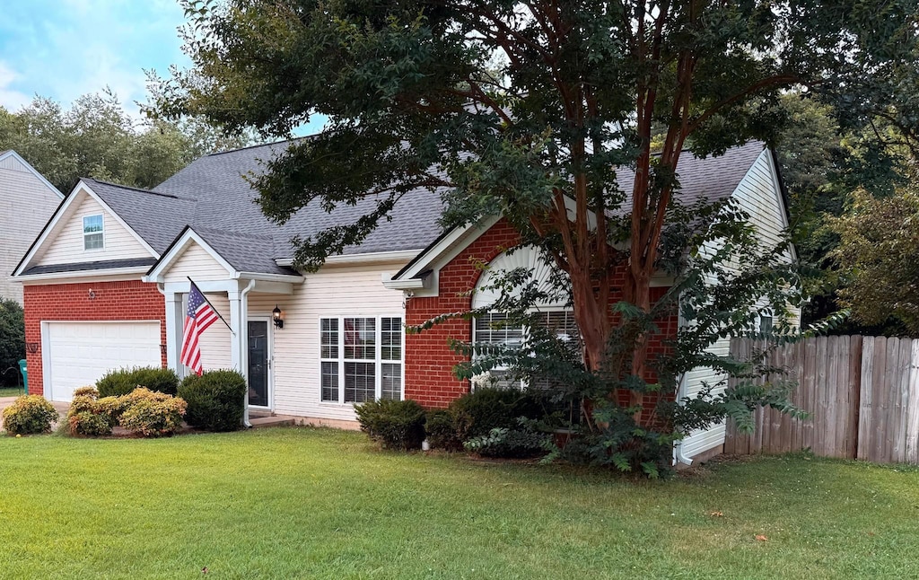2127 Loudenslager Dr, Thompsons Station, TN 37179 - view of front of home with a garage, brick siding, and roof with shingles