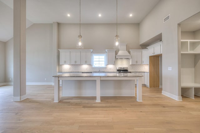 5560 Sinclair Ct, Murfreesboro, TN 37127 - kitchen featuring premium range hood, stainless steel range with electric stovetop, high vaulted ceiling, white cabinetry, and decorative backsplash