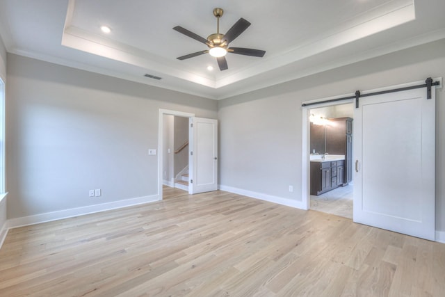 5560 Sinclair Ct, Murfreesboro, TN 37127 - unfurnished bedroom with a barn door, a tray ceiling, ornamental molding, light wood finished floors, and recessed lighting