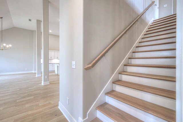 5560 Sinclair Ct, Murfreesboro, TN 37127 - stairs featuring a chandelier, wood finished floors, and lofted ceiling