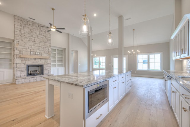 5560 Sinclair Ct, Murfreesboro, TN 37127 - kitchen featuring stainless steel microwave, open floor plan, ceiling fan, light wood-type flooring, and high vaulted ceiling