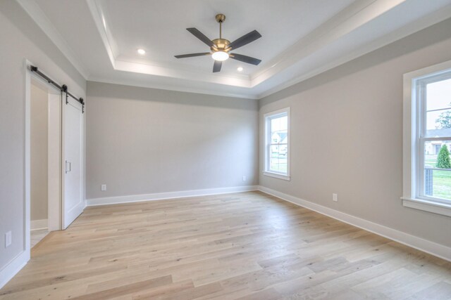 5560 Sinclair Ct, Murfreesboro, TN 37127 - unfurnished bedroom with a tray ceiling, a barn door, crown molding, light wood finished floors, and recessed lighting