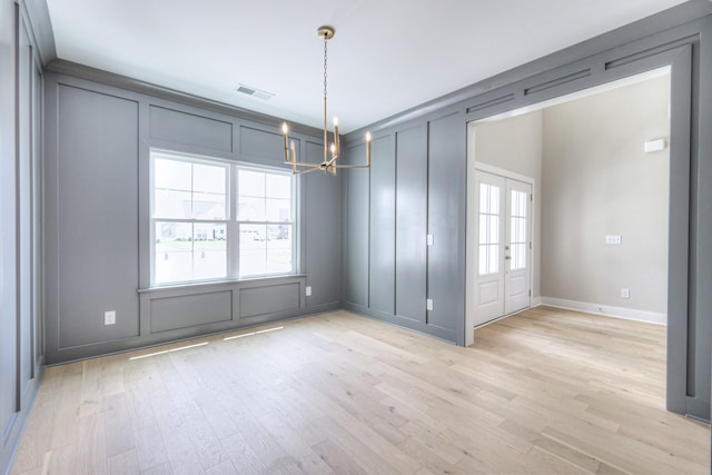 4113 Cile Ct, Murfreesboro, TN 37127 - unfurnished dining area with light wood-style flooring, a decorative wall, and a chandelier