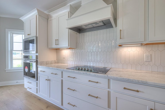 4113 Cile Ct, Murfreesboro, TN 37127 - kitchen featuring stainless steel appliances, premium range hood, white cabinets, light wood finished floors, and tasteful backsplash