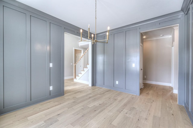 4113 Cile Ct, Murfreesboro, TN 37127 - unfurnished dining area with a decorative wall, light wood-style floors, a chandelier, and stairs