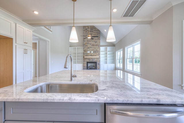 4113 Cile Ct, Murfreesboro, TN 37127 - kitchen featuring stainless steel dishwasher, vaulted ceiling, light stone countertops, a fireplace, and open floor plan