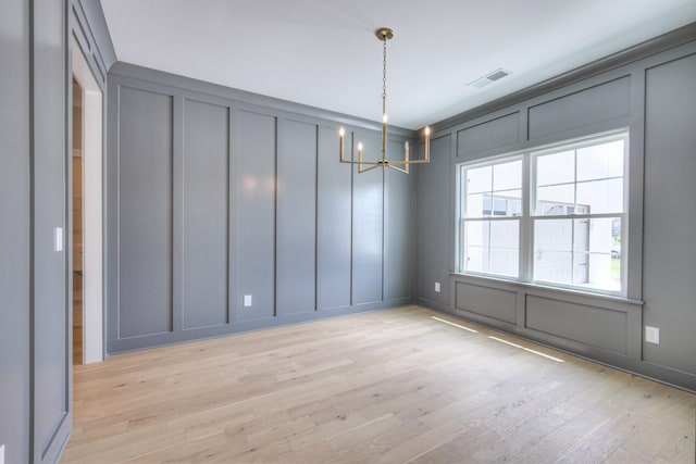 4113 Cile Ct, Murfreesboro, TN 37127 - spare room featuring a decorative wall, a chandelier, and light wood-style flooring