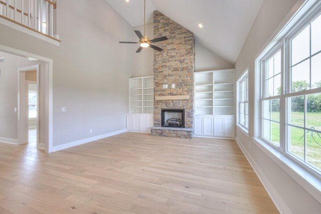 4113 Cile Ct, Murfreesboro, TN 37127 - unfurnished living room featuring light wood-type flooring, high vaulted ceiling, ceiling fan, a stone fireplace, and built in shelves