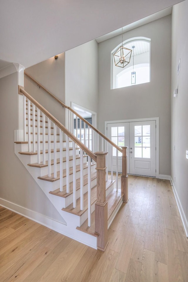 4113 Cile Ct, Murfreesboro, TN 37127 - staircase featuring a chandelier, wood-type flooring, plenty of natural light, and a high ceiling