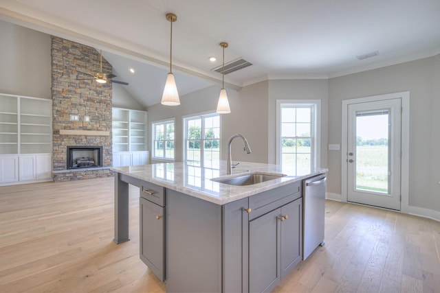 4113 Cile Ct, Murfreesboro, TN 37127 - kitchen with gray cabinetry, stainless steel dishwasher, light wood-type flooring, a fireplace, and light stone counters