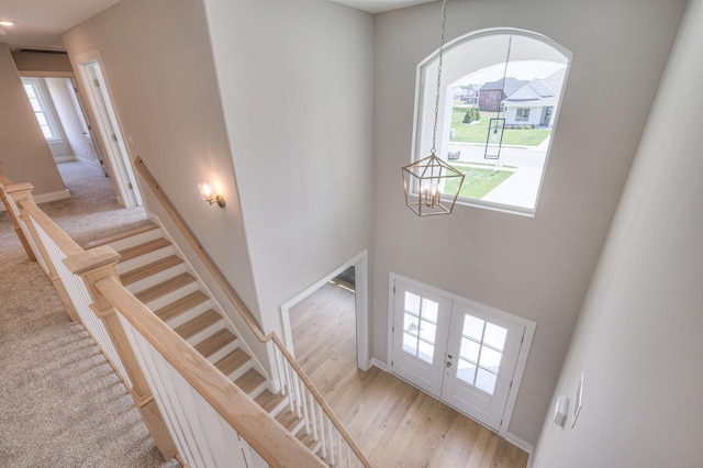 4113 Cile Ct, Murfreesboro, TN 37127 - stairway with a chandelier, carpet, french doors, and a towering ceiling