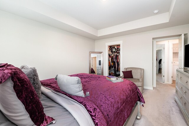 1704 Lannister Ave, Murfreesboro, TN 37128 - bedroom featuring light colored carpet, a raised ceiling, and a walk in closet