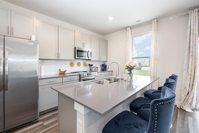 1704 Lannister Ave, Murfreesboro, TN 37128 - kitchen featuring stainless steel appliances, wood finished floors, tasteful backsplash, an island with sink, and recessed lighting