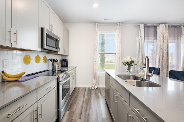 1704 Lannister Ave, Murfreesboro, TN 37128 - kitchen featuring stainless steel appliances, dark wood-style floors, decorative backsplash, light countertops, and recessed lighting
