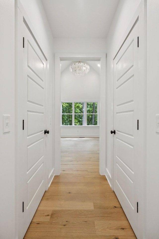 1007 Pheasant Ct, Kingston Springs, TN 37082 - hallway with a chandelier and light wood finished floors