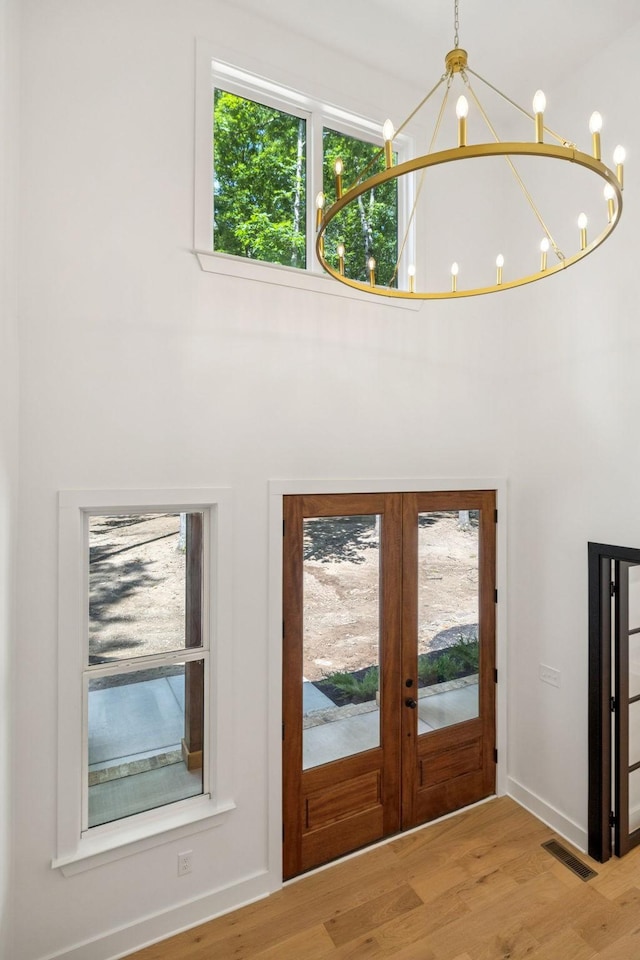 1007 Pheasant Ct, Kingston Springs, TN 37082 - entrance foyer with a chandelier, french doors, and wood finished floors