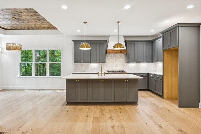 1007 Pheasant Ct, Kingston Springs, TN 37082 - kitchen with gray cabinets, light countertops, backsplash, light wood-style flooring, and recessed lighting