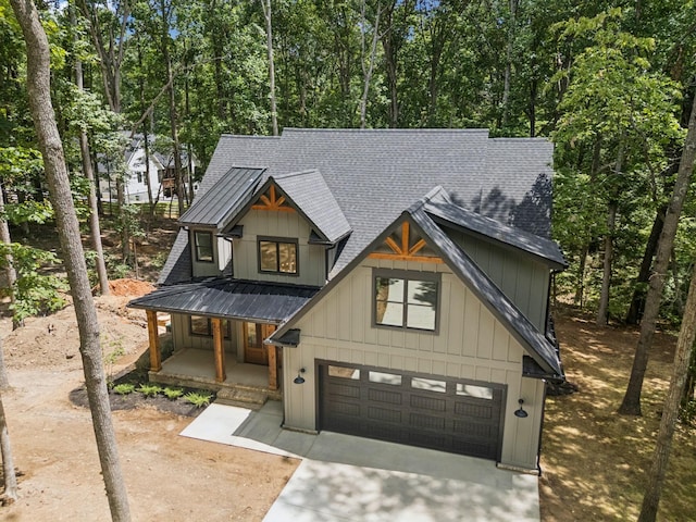 1007 Pheasant Ct, Kingston Springs, TN 37082 - modern farmhouse with a shingled roof, concrete driveway, a porch, and a garage