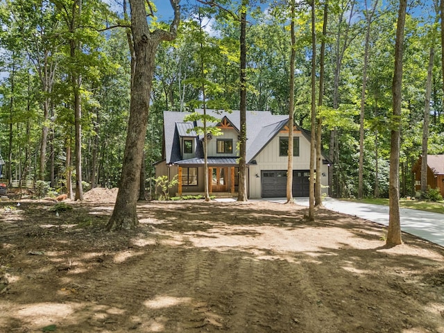 1007 Pheasant Ct, Kingston Springs, TN 37082 - view of front of home with concrete driveway, board and batten siding, and a garage