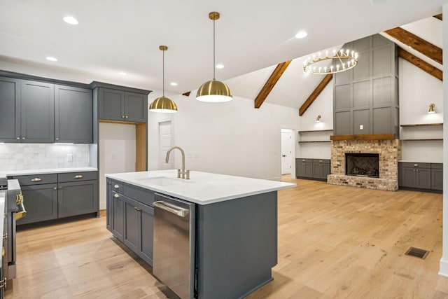 1007 Pheasant Ct, Kingston Springs, TN 37082 - kitchen featuring stainless steel dishwasher, open floor plan, backsplash, light countertops, and light wood-style floors