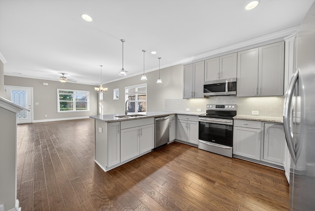 751 Pebble Creek Ln, Lebanon, TN 37090 - kitchen featuring stainless steel appliances, a peninsula, tasteful backsplash, open floor plan, and crown molding