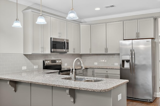 751 Pebble Creek Ln, Lebanon, TN 37090 - kitchen with appliances with stainless steel finishes, a peninsula, ornamental molding, a breakfast bar, and decorative light fixtures