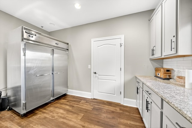 751 Pebble Creek Ln, Lebanon, TN 37090 - kitchen with wood finished floors, decorative backsplash, light stone countertops, stainless steel built in refrigerator, and recessed lighting