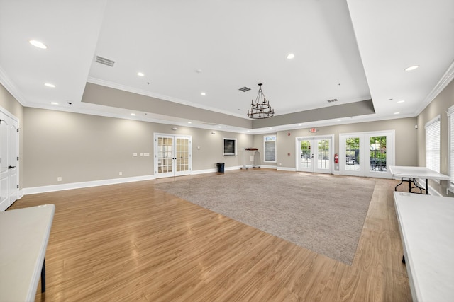 751 Pebble Creek Ln, Lebanon, TN 37090 - unfurnished living room with french doors, a raised ceiling, ornamental molding, light wood-style floors, and recessed lighting