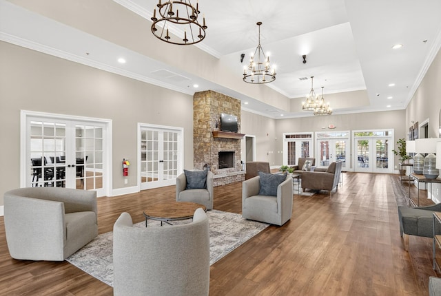 751 Pebble Creek Ln, Lebanon, TN 37090 - living room with french doors, ornamental molding, a chandelier, a raised ceiling, and a stone fireplace