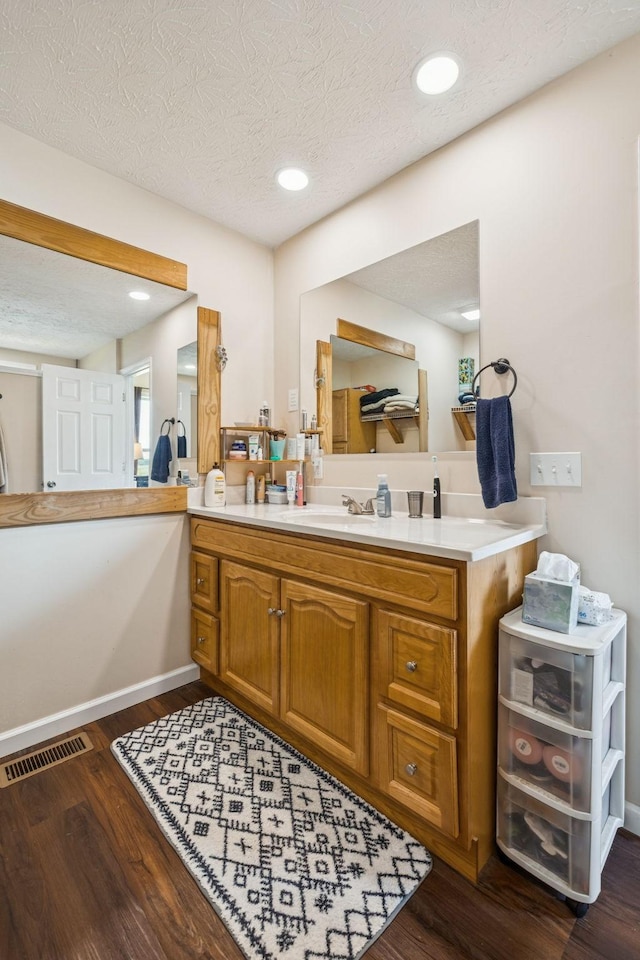 906 Freeman St, Lafayette, TN 37083 - bathroom with wood finished floors, vanity, a textured ceiling, and recessed lighting