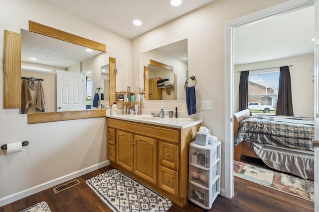 906 Freeman St, Lafayette, TN 37083 - bathroom with ensuite bath, vanity, wood finished floors, recessed lighting, and a textured ceiling