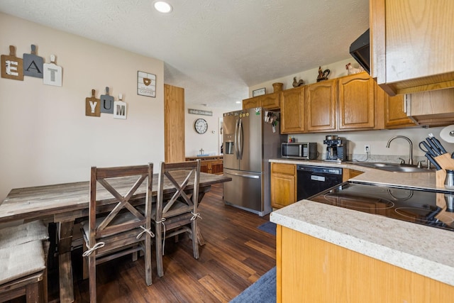 906 Freeman St, Lafayette, TN 37083 - kitchen featuring appliances with stainless steel finishes, dark wood-style floors, brown cabinets, light countertops, and recessed lighting