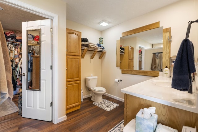 906 Freeman St, Lafayette, TN 37083 - bathroom with wood finished floors, vanity, a walk in closet, and a textured ceiling