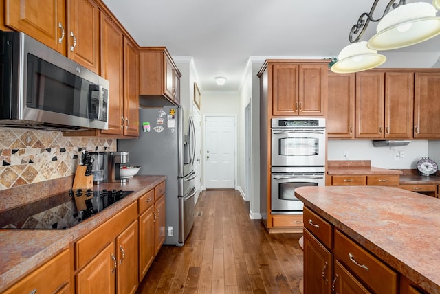4305 Minette Ct, Mount Juliet, TN 37122 - kitchen with appliances with stainless steel finishes, brown cabinetry, dark wood finished floors, tasteful backsplash, and crown molding