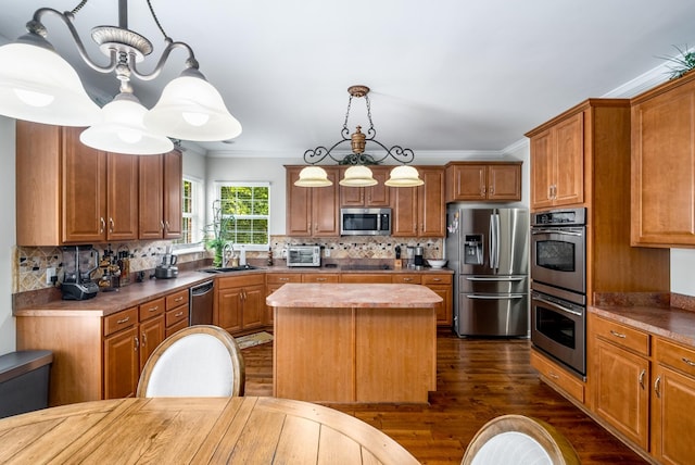4305 Minette Ct, Mount Juliet, TN 37122 - kitchen featuring appliances with stainless steel finishes, dark wood-style floors, a center island, decorative backsplash, and ornamental molding