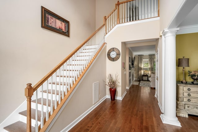 4305 Minette Ct, Mount Juliet, TN 37122 - staircase featuring ornate columns, hardwood / wood-style floors, and a towering ceiling