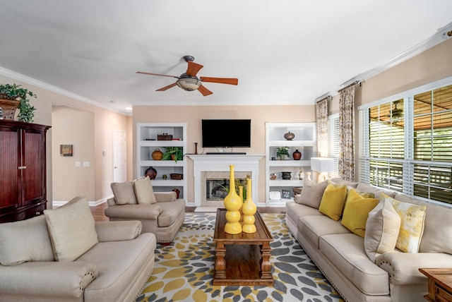 4305 Minette Ct, Mount Juliet, TN 37122 - living area with ceiling fan, built in shelves, crown molding, and a glass covered fireplace