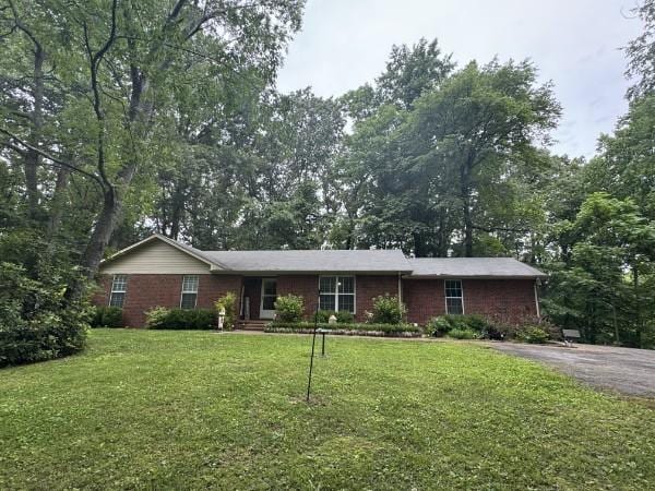 7115 Littlejohn Ln, Fairview, TN 37062 - ranch-style home featuring a front lawn and asphalt driveway